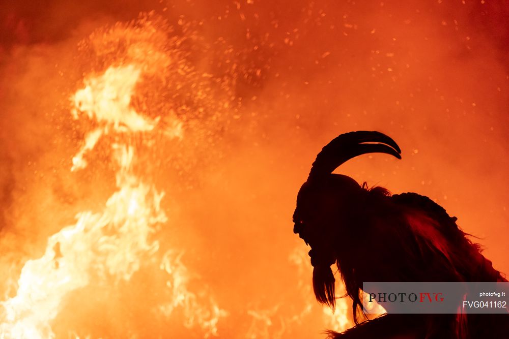 Silhouette of Krampus in the flames, Christmas devils, Tarvisio, Friuli Venezia Giulia, Italy, Europe