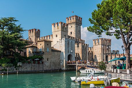 Tourists visiting the historic Scaliger Castle of Sirmione, Garda lake, Brescia, Lombardy, Italy