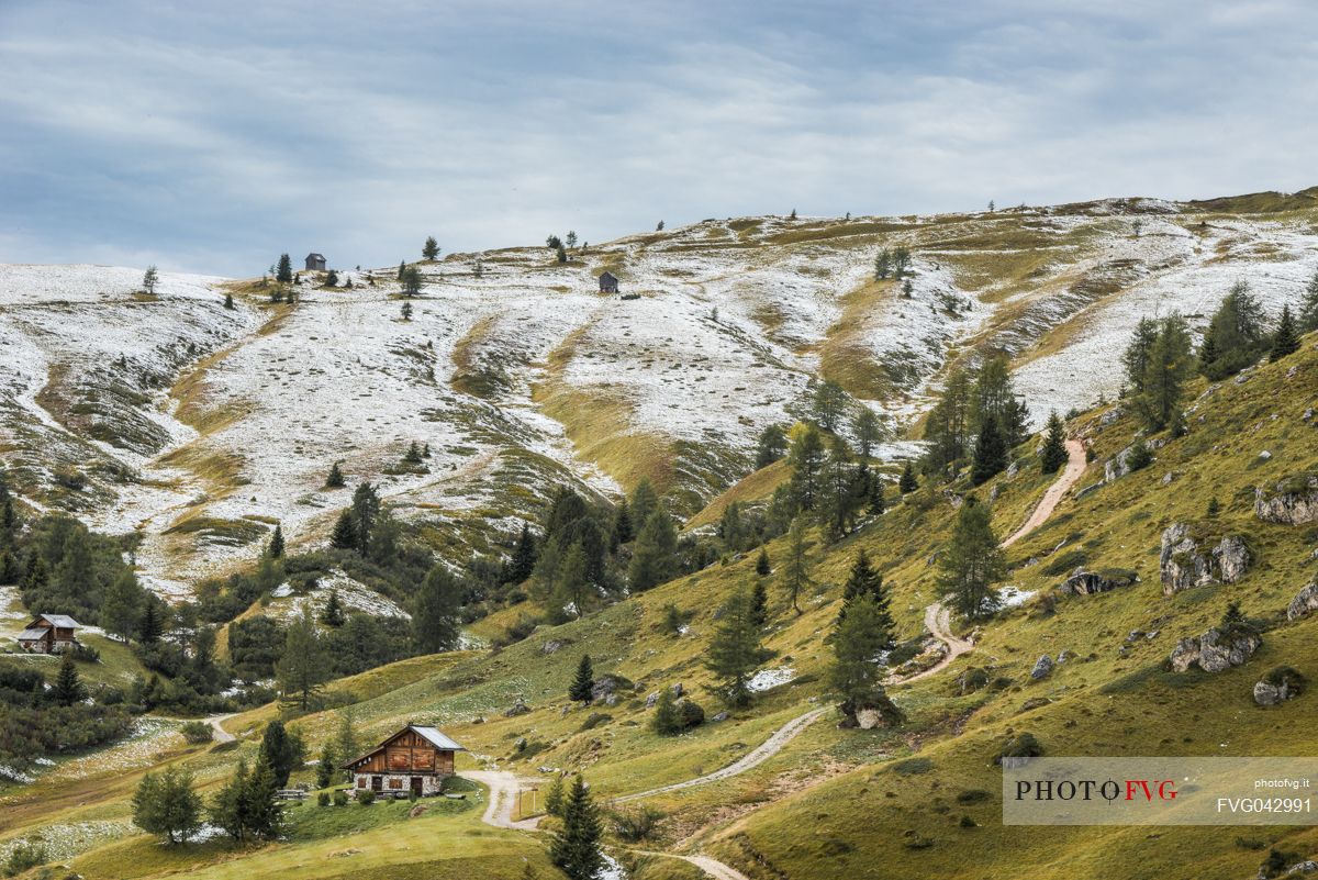 Meadows of the Giau pass partly covered by a dusting of snow, dolomites, Cortina d'Ampezzo, Veneto, Italy
