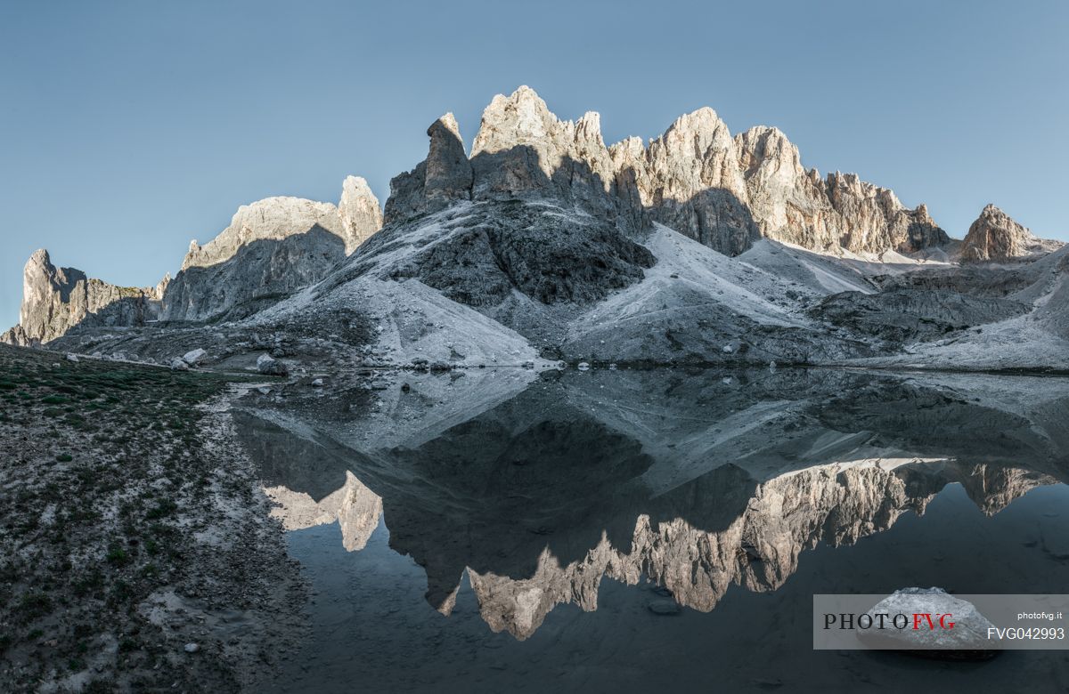 Pale di San Martino reflected in the Pradidali lake at the first light of day, dolomites, Trentino Alto Adige, Italy, Europe