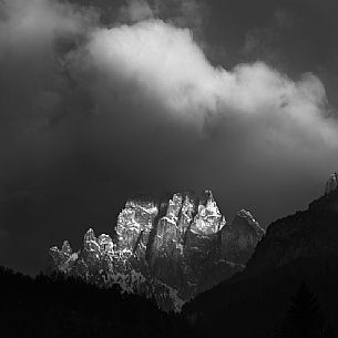 The Larsech mountain in the Catinaccio mountain range, lightened by a ray of light emerged from the thunder clouds, Fassa valley, dolomites, Trentino Alto Adige, Italy, Europe