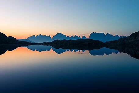 Brenta mountain range skyline at the dusk reflected on the Lago Nero of Cornisello, Nambrone valley, Madonna di Campiglio, Trentino Alto Adige, dolomites, Italy, Europe