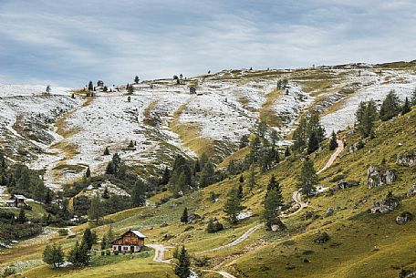 Meadows of the Giau pass partly covered by a dusting of snow, dolomites, Cortina d'Ampezzo, Veneto, Italy