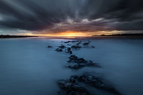 Rocks pointing at sunset  after a storm, Bibione, Adriatic sea, Veneto, Italy, Europe