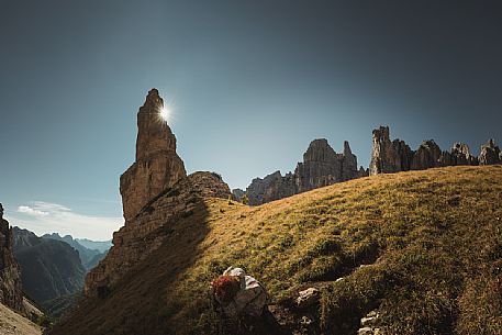 The sun peeks out behind the Campanile di Val Montanaia bell tower, Dolomiti Friulane natural park, dolomites, Friuli Venezia Giulia, Italy, Europe