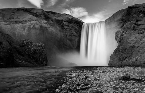 A black and white view of Skgafoss waterfall