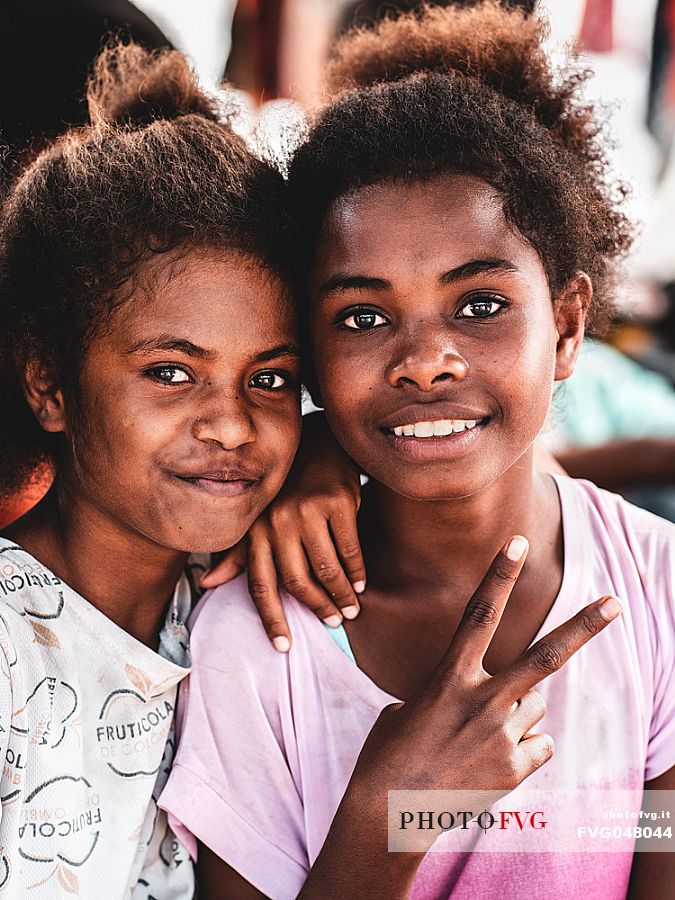 Portrait of a couple of indigenous sisters in the village of of Sauwandarek in the Raja Ampat archipelago, West Papua, Indonesia