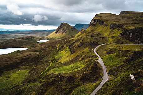 Tourist road crosses the lunar landscape of Quiraing, Trotternish Peninsula in the Isle of Skye, Highands, Scotland, United Kingdom, Europe