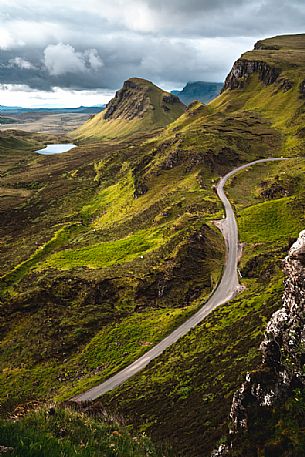 Tourist road crosses the lunar landscape of Quiraing, Trotternish Peninsula in the Isle of Skye, Highands, Scotland, United Kingdom, Europe