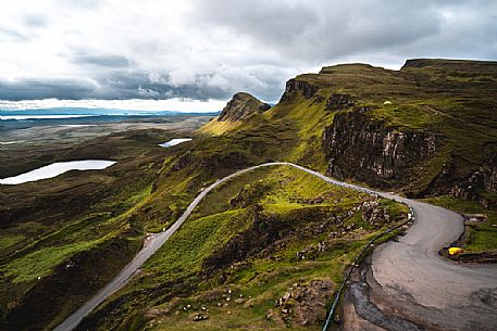 Tourist road crosses the lunar landscape of Quiraing, Trotternish Peninsula in the Isle of Skye, Highands, Scotland, United Kingdom, Europe