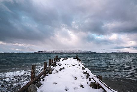 Old pier on the shoreline near Bakkejord, on the road Leirstrandvegen to Tromso, Norway, Europe