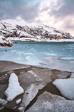 View of the frozen sea and the hill on the island of Sommary, Troms, Norway, Europe
