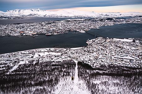 Winter cityscape of Tromso. The panoramic view over the island of Tromsoya can be easily admired from the Storsteinen Mountain thanks to a cable car. From above you can even see the snow-capped mountains on Kvaloya Island in the background, Norway, Europe