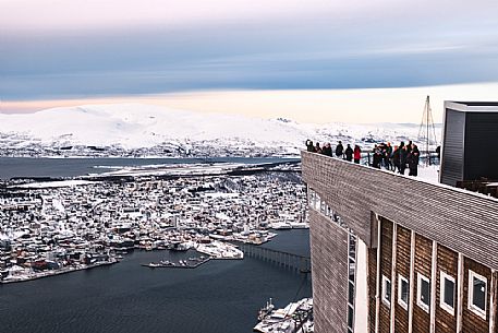Tourists on the top Station of Fjellheisen Cable Car on Storsteinen Mountain (418m) with view of the city and Tromsoysund, Tromso, Norway, Europe