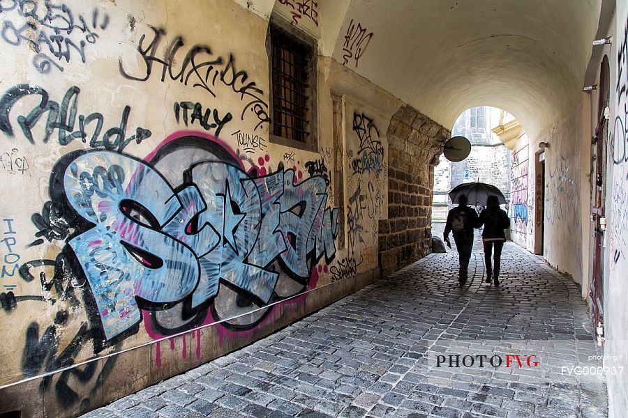 A narrow street with graffiti in Prague old town, Star Mesto
