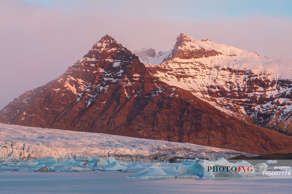 First lights of dawn in a glacier lagoon