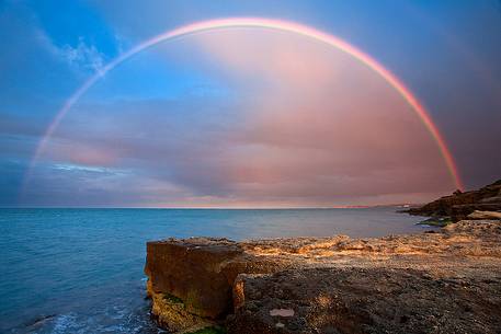 A huge rainbow over the sea at sunset
