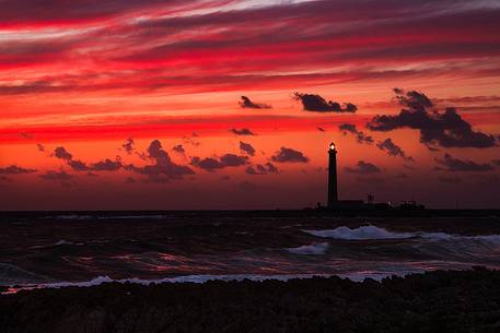 A fiery sunset in Favignana, in the background the lighthouse of Punta Sottile.