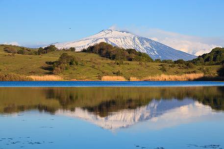 Etna is reflected on the lake Biviere