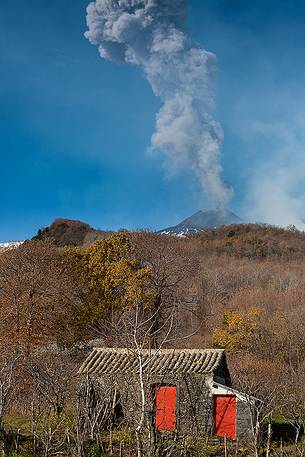 Rural cottage, in background Etna smoke activity