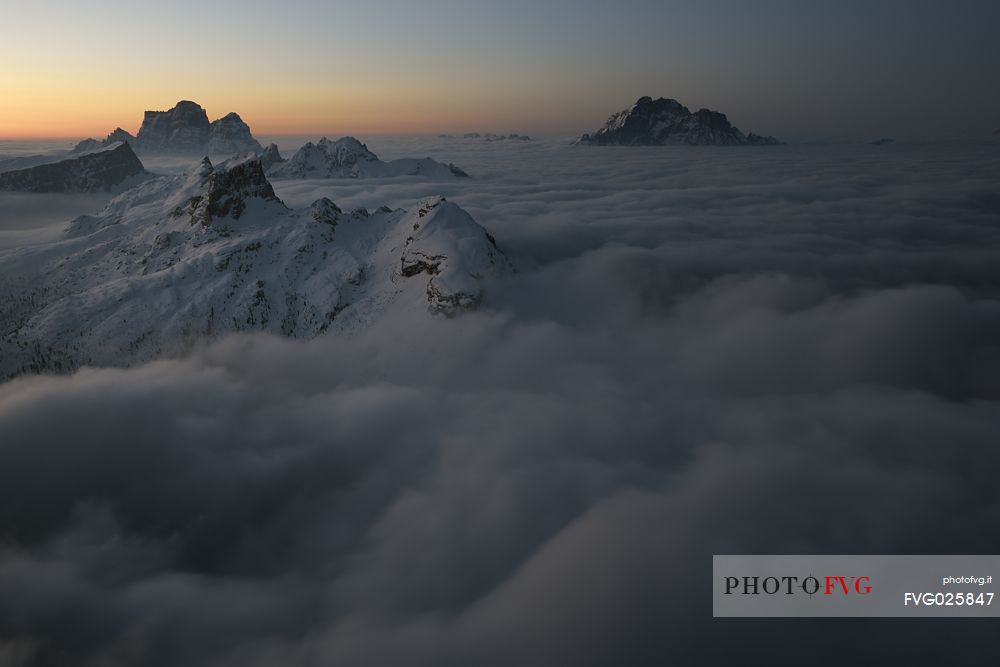Sunrise from the top of the mountain Lagazuoi towards the Dolomites of Cortina and Zoldana valley.
Cold and windy winter morning with the phenomenon of thermal inversion, dolomites, Italy