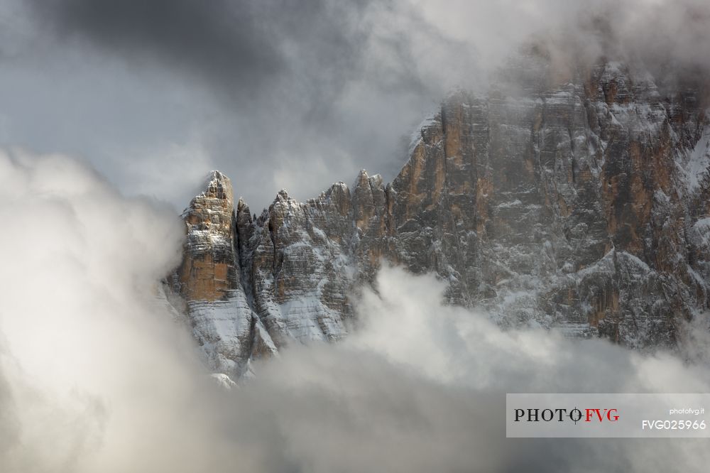 The north-west wall of the Civetta mount wrapped in stormy cloud, dolomites, Italy