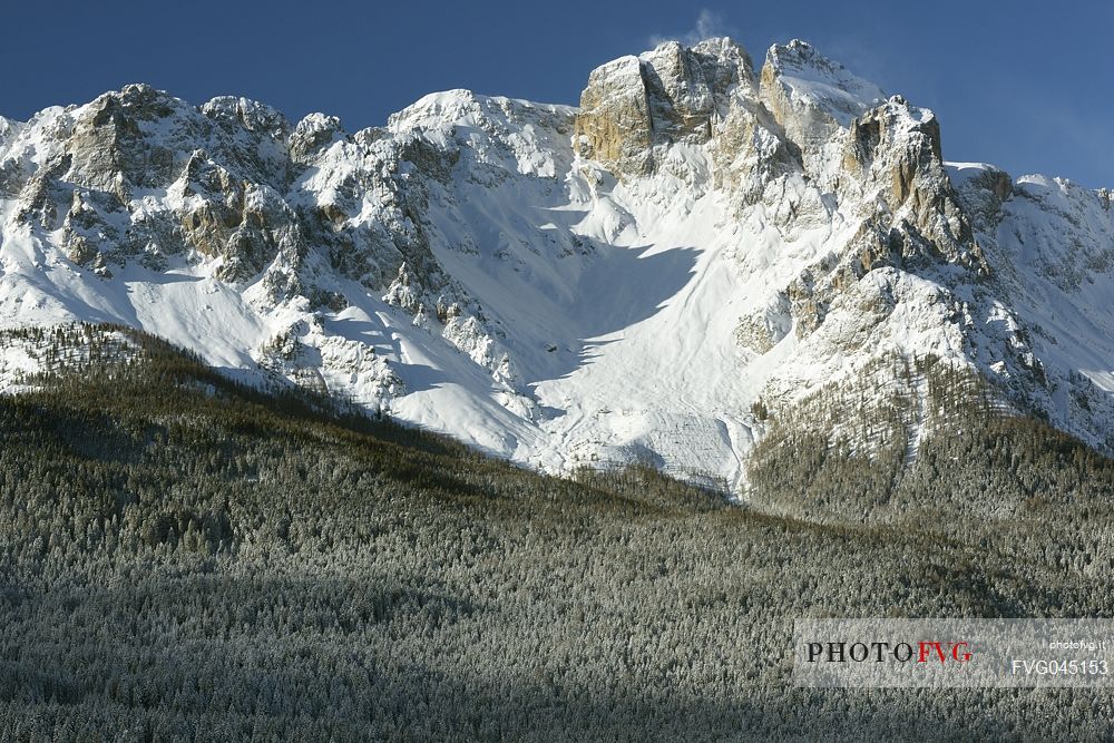 Comelico valley in a winter day, in the background the Croda da Campo peak in the Sesto dolomites, Veneto, Italy, Europe