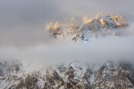 Last lights and fog on Mount Teverone, prealps carniche, Alpago, Veneto, Italy, Europe