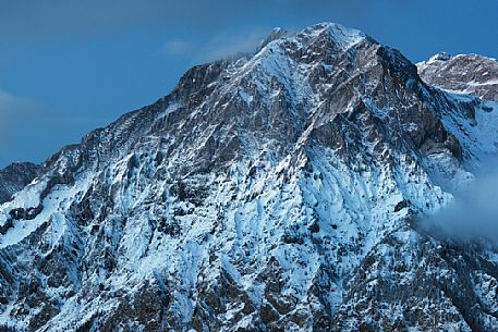 Last lights and fog on Mount Teverone, prealps carniche, Alpago, Veneto, Italy, Europe