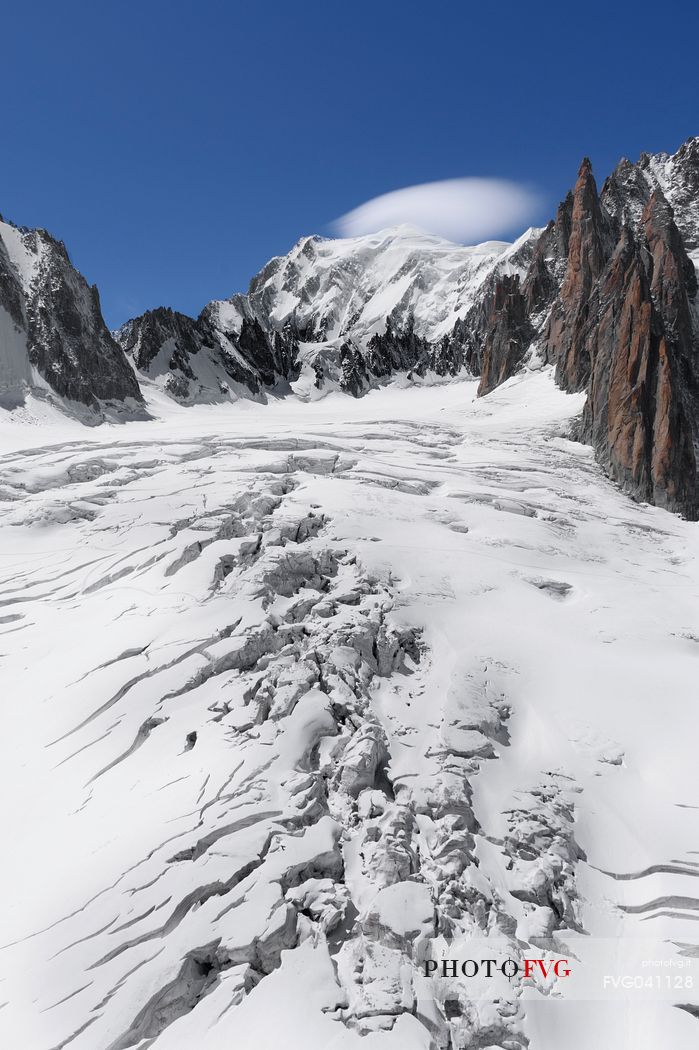 Top of Mont Blanc wrapped in lenticular cloud, crevasse on the Glacier du Gant, Courmayeur, Aosta valley, Italy, Europe