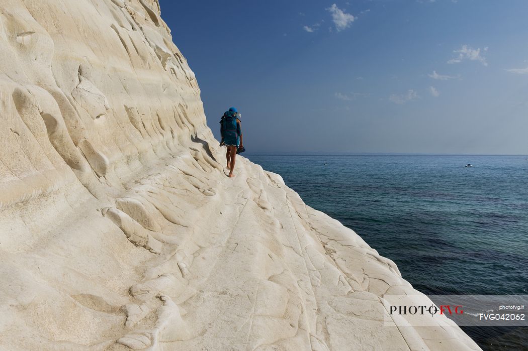 Sea, sky, rock and a person on steep path of the Scala dei Turchi, Realmonte, Agrigento, Sicily, Italy, Europe