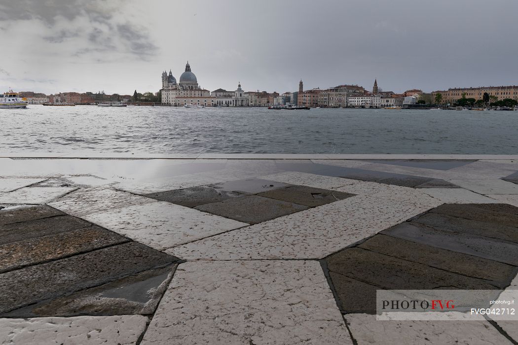 View of the Basilica of Santa Maria della Salute from the island of San Giorgio on a rainy afternoon, Venice, Italy, Europe