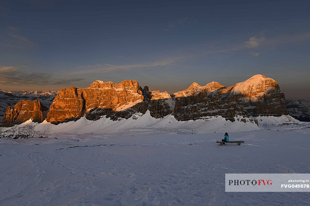 Hiker near the summit of Piccolo Lagazuoi,  admires the Fanis and Tofane mountains at sunset, Falzarego, dolomites, Cortina d'Ampezzo, Veneto, Italy, Europe