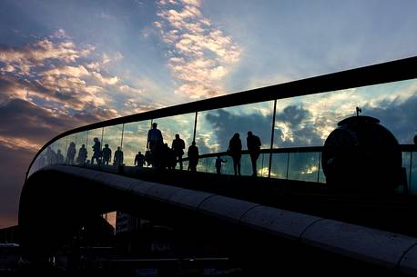 Come back home. It's evening and people cross Calatrava bridge that brings them back to the mainland, Venice, Italy, Europe