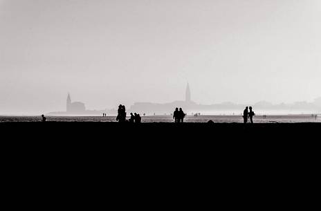 Whispers in the promenade of Caorle. Sillhouette at sunset on a foggy october evening, Caorle, Veneto, Italy, Europe