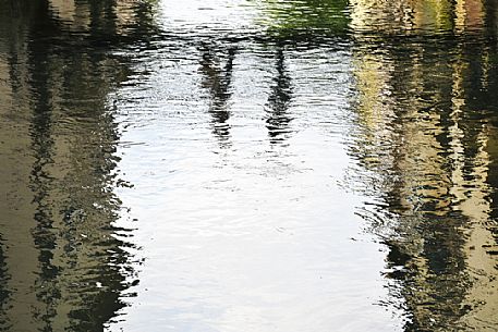 Shadow of people on th Buranelli little bridge in Treviso reflected in the canal, Treviso, Veneto, Italy, Europe