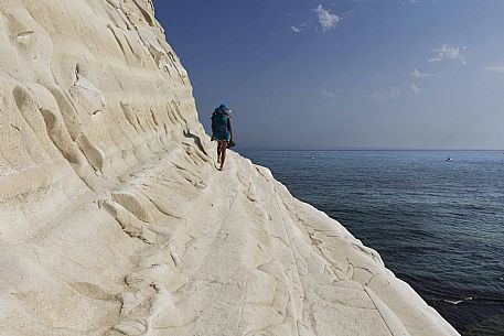 Sea, sky, rock and a person on steep path of the Scala dei Turchi, Realmonte, Agrigento, Sicily, Italy, Europe