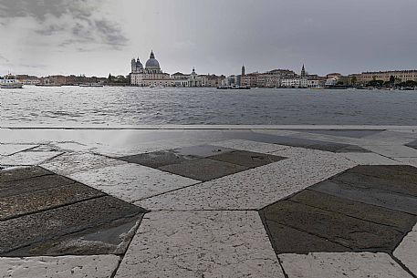 View of the Basilica of Santa Maria della Salute from the island of San Giorgio on a rainy afternoon, Venice, Italy, Europe