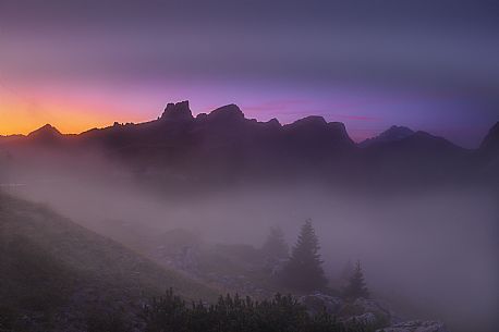 Dawn shrouded in mist from the Pass of Valparola. Antelao, Averau and Nuvolau dominate