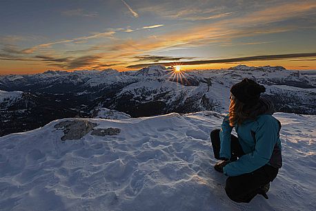 Hiker near the summit of Piccolo Lagazuoi waiting for the sunset behind the Marmolada massif, Cortina d'Ampezzo, dlomites, Veneto, Italy, Europe