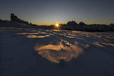 Beautiful sunrise behind Le Ciampedele, between the western side of the Tre Cime di Lavaredo and the Cadini di Misurina, on a frosty december morning, dolomites, South Tyrol, Italy, Europe