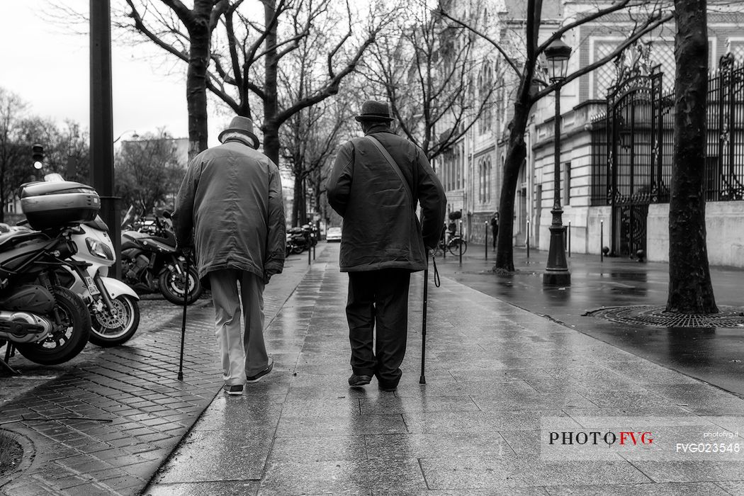 Two walking men in avenue de Friedland in Paris, France