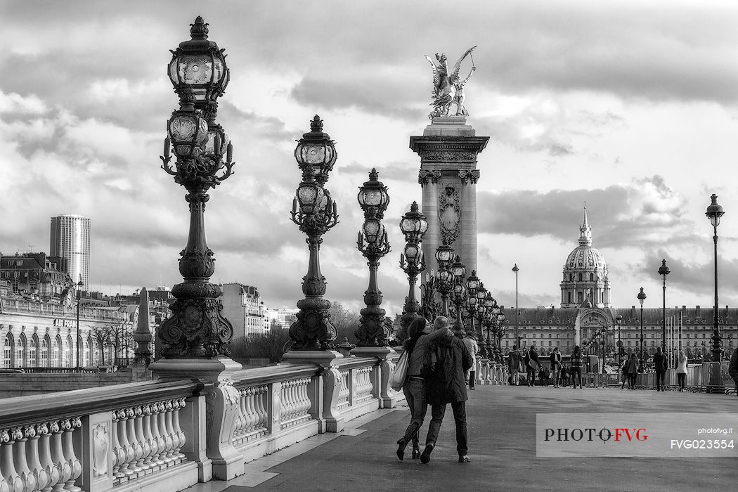 Lovers kissing over Alexander III Bridge.Paris, France
