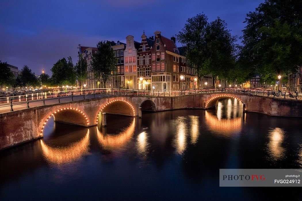 A view of the bridges at the Leidsegracht and Keizersgracht canals intersection in Amsterdam at dusk,Holland