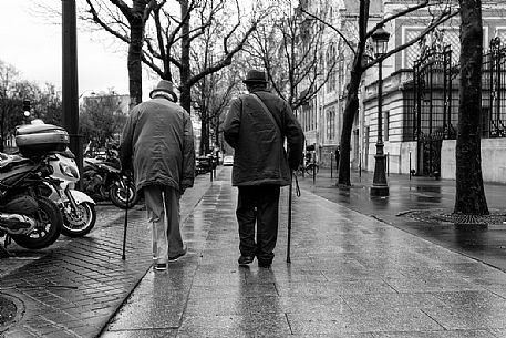 Two walking men in avenue de Friedland in Paris, France