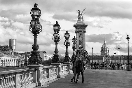 Lovers kissing over Alexander III Bridge.Paris, France