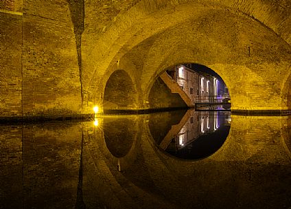 Details and reflections of Triple-bridge, Ponte dei Trepponti, called Ponte Pallotta (1638 Luca Danese architect), famous bridge landmark of town of Comacchio