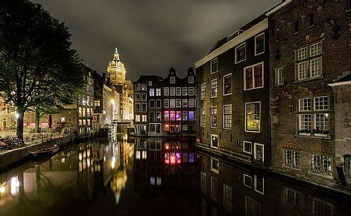 De Wallen, the largest and historic red lights district in Amsterdam, the canal Oudezijds Voorburgwal and the Basilica of Saint Nicholas and its mirror reflection, Holland, Netherlands.
