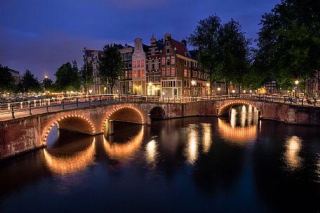 A view of the bridges at the Leidsegracht and Keizersgracht canals intersection in Amsterdam at dusk,Holland