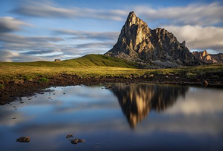 Mirror reflection of Ra Gusela mountain at sunrise, Giau pass, Cortina d'Ampezzo, Italy